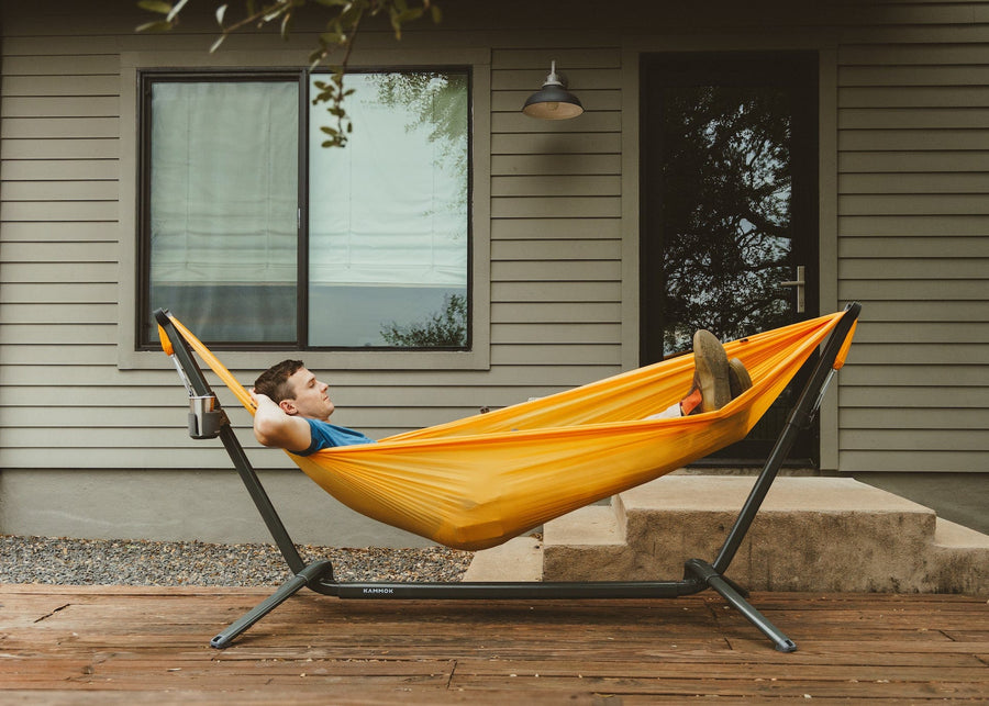 Man lounging in our portable swiftlet stand outside his back door.