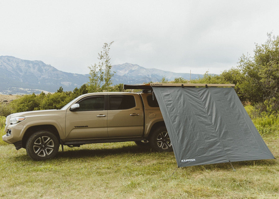 Kammok Crosswing Shade Panel installed on a truck with mountains in the background.