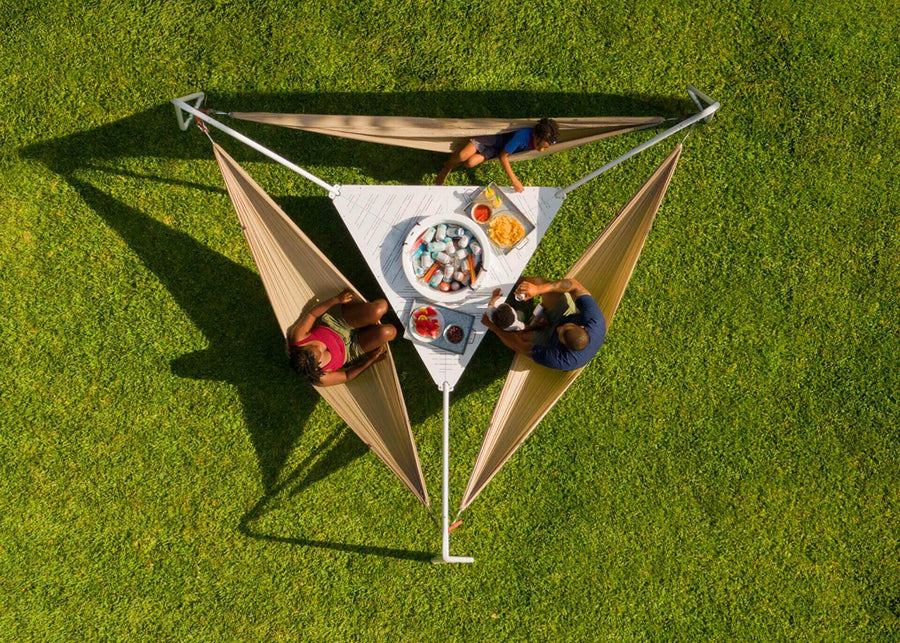 Arial shot of a family sitting in Hammocks around their Kammok Stand Baya 2.0 with food and drinks in the center.
