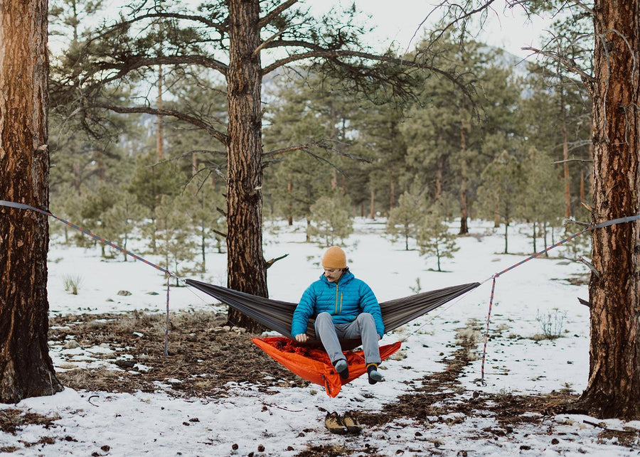 Man sitting on his hammock over a Kammok Storage Joey Gear Sling