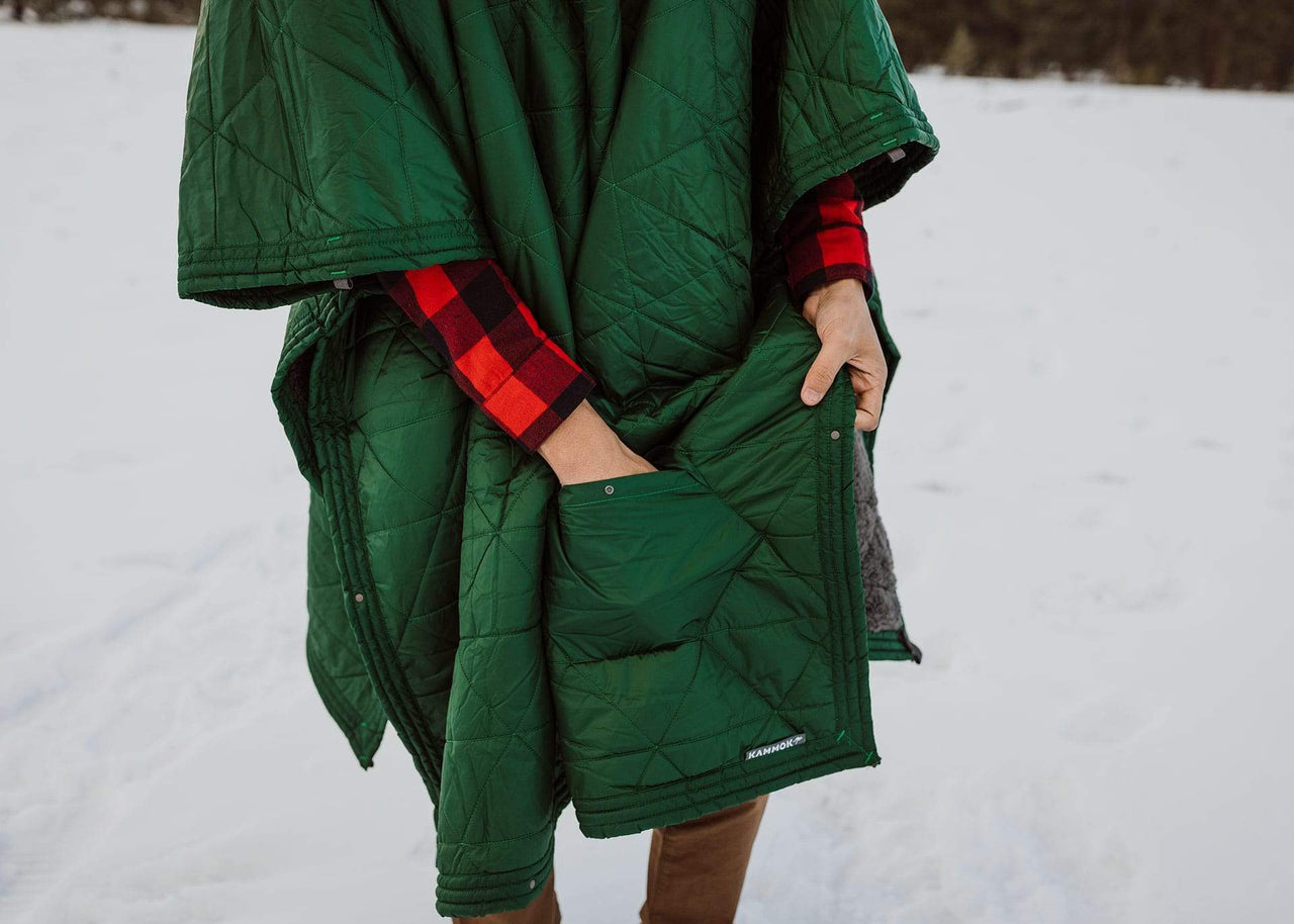 Zoomed in shot of man reaching his hand into a Kammok Blanket Mountain Blanket pocket.