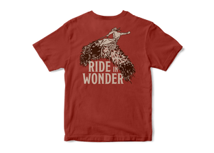 Studio photo a Kammok Ride in Wonder Tee in red with a graphic of a woolly bear caterpillar and text Ride in Wonder.