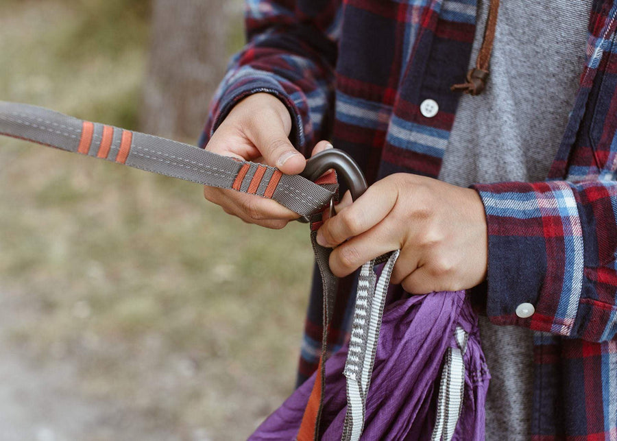Close up of person attaching Kammok Roo Hammock to Python Straps.