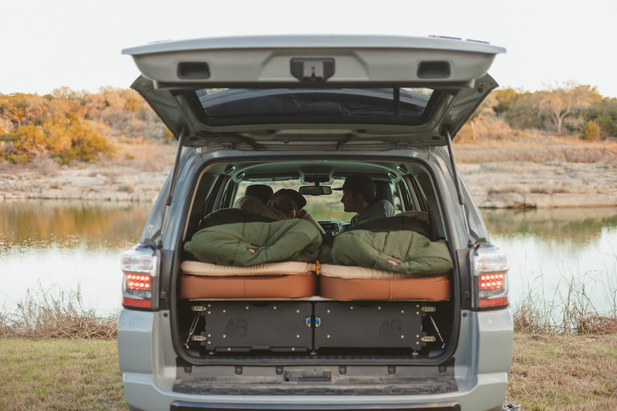 Two Kammok Ursa Sleep Systems in the back of a truck with campers.