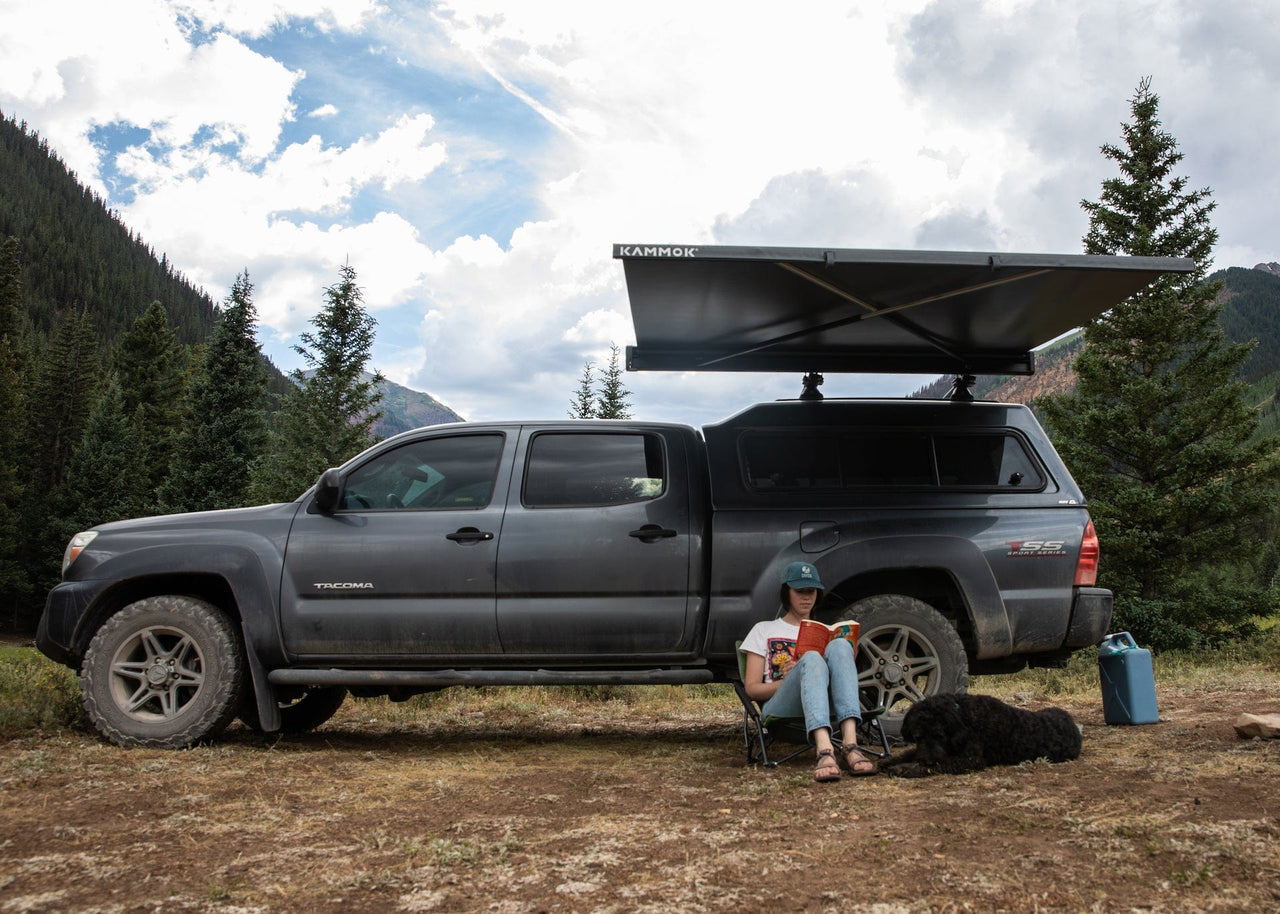 Crosswing Adjustable Coverage - Customer Reading Book with Dog Under Crosswing Awning