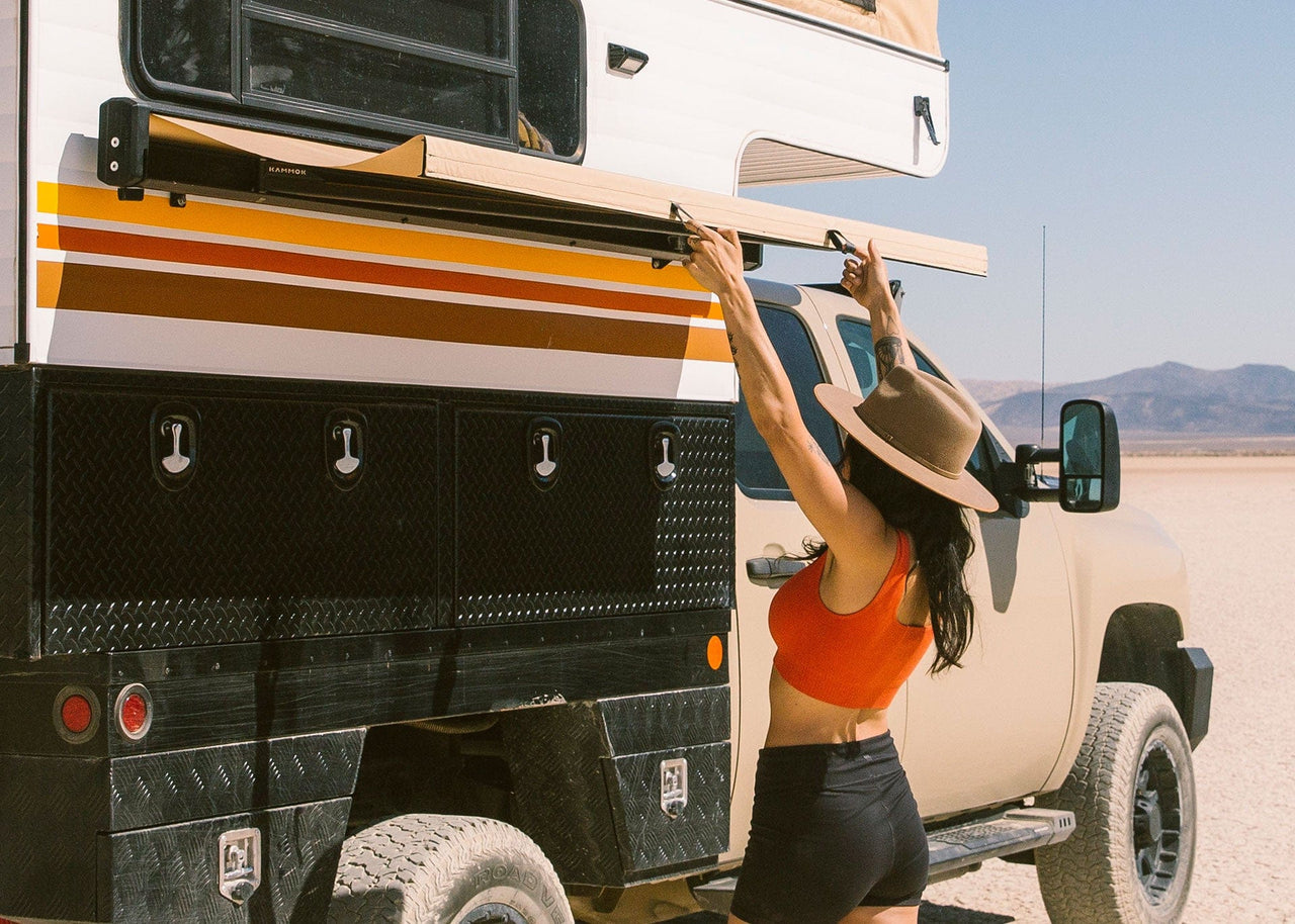 Women next to camper opening up her Crosswing.