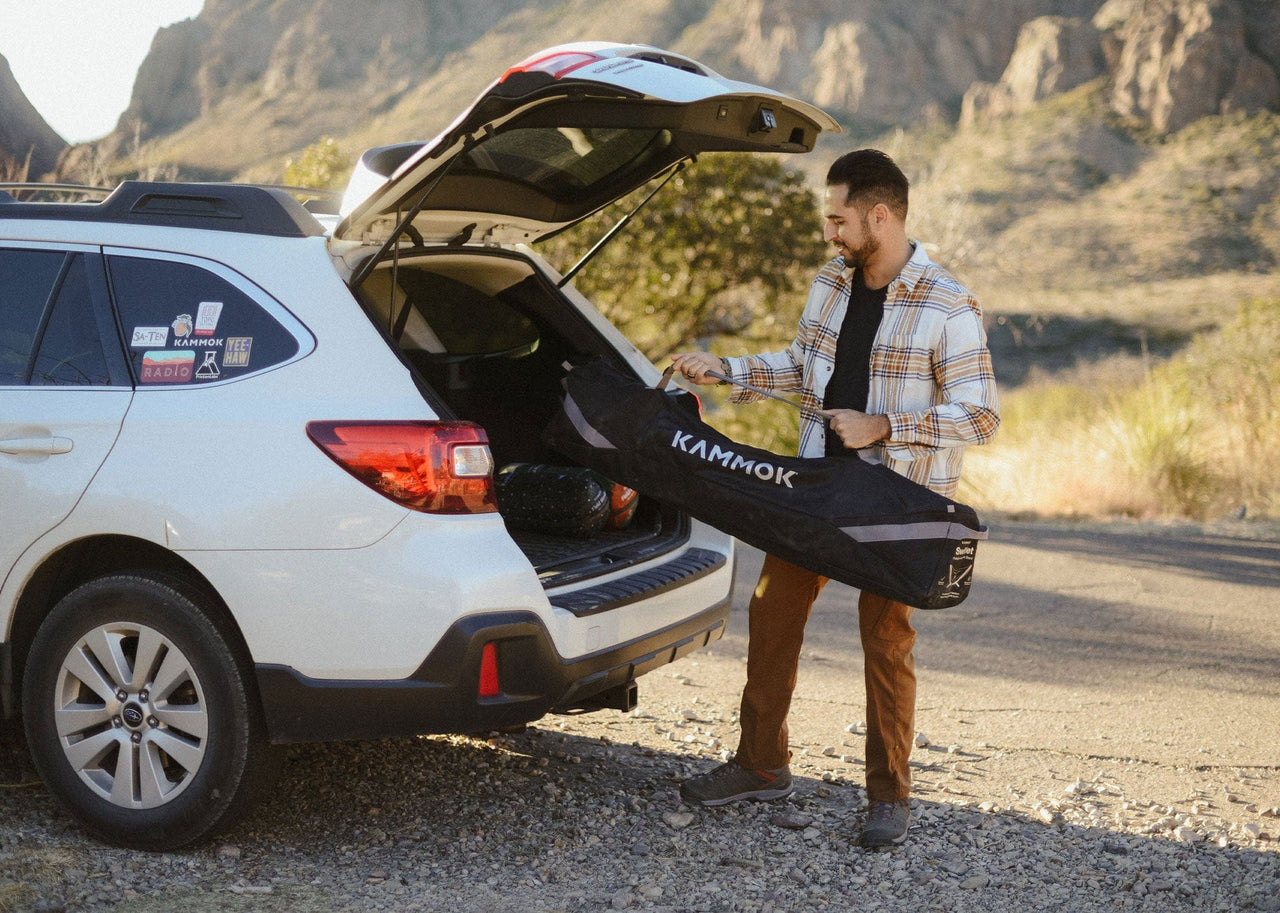 Man loading his Kammok Stand Swiftlet into his car in carrying bag.