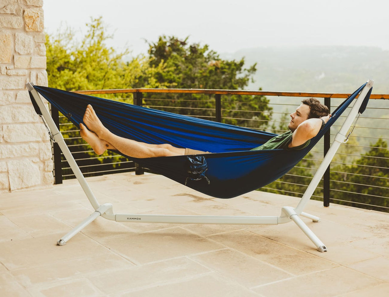 Man lounging in our new limestone Kammok Stand Swiftlet