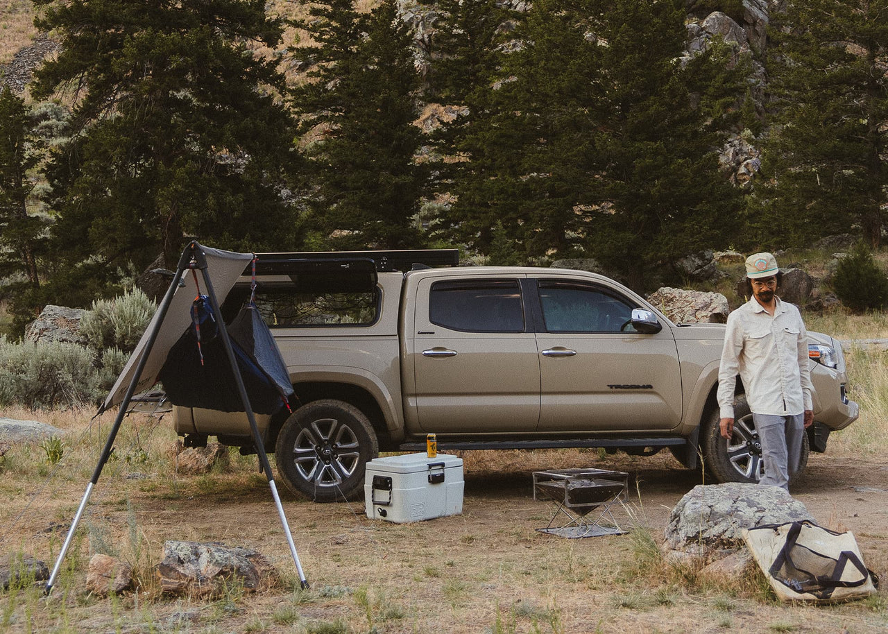 Man walking away from truck next to an installed Kammok Bundle Outpost Overland Bundle