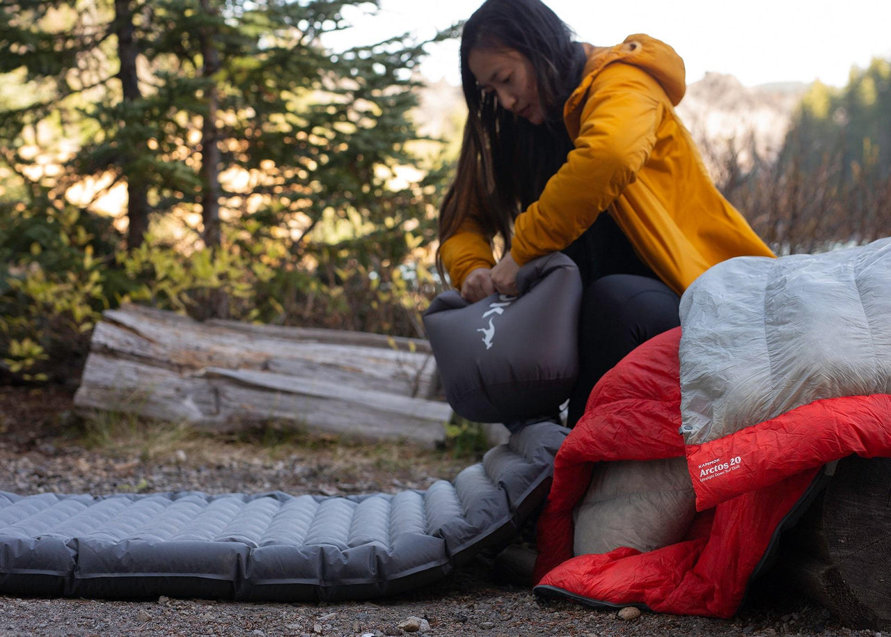 Women using a pongo air pump in woods.