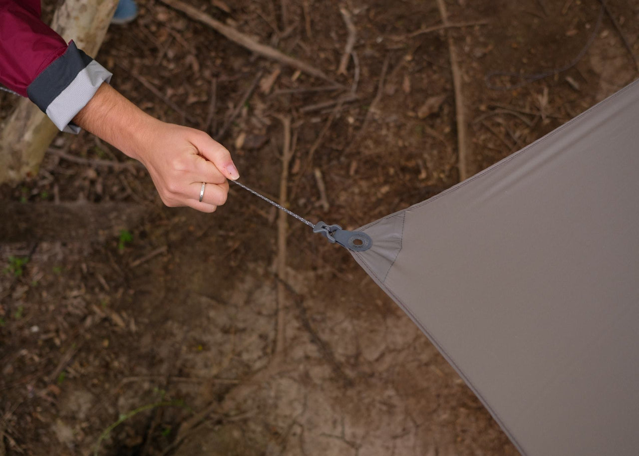 Close up of women's hands tightening Kammok Weather Shelter Kuhli UL