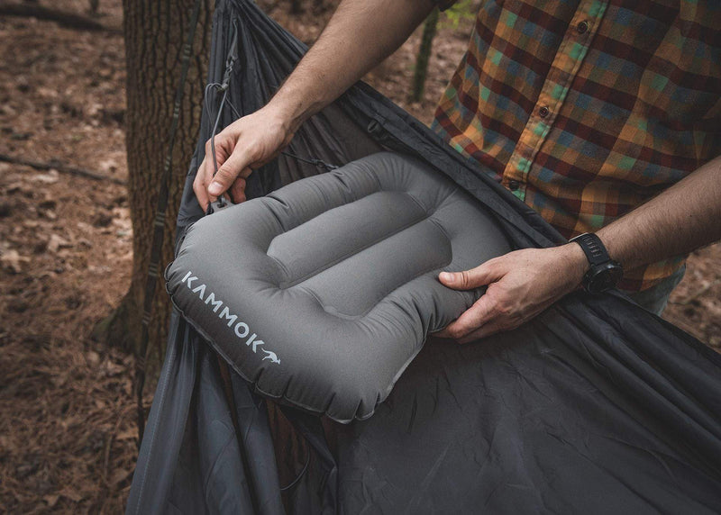 Close up of man connecting a Kammok Sleep Line Puffin Pillow on a Roo Hammock.