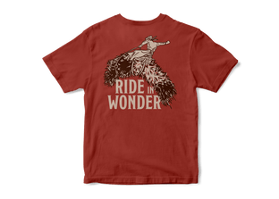 Studio photo a Kammok Ride in Wonder Tee in red with a graphic of a woolly bear caterpillar and text Ride in Wonder. 