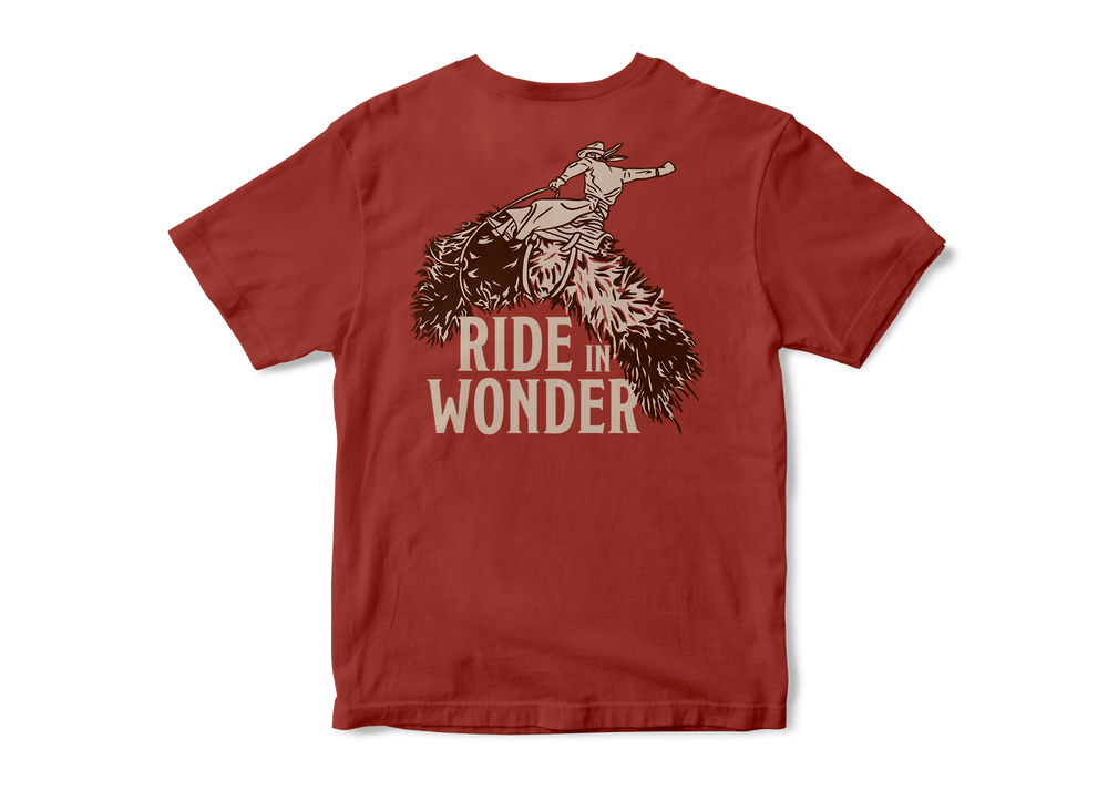 Studio photo a Kammok Ride in Wonder Tee in red with a graphic of a woolly bear caterpillar and text Ride in Wonder. 