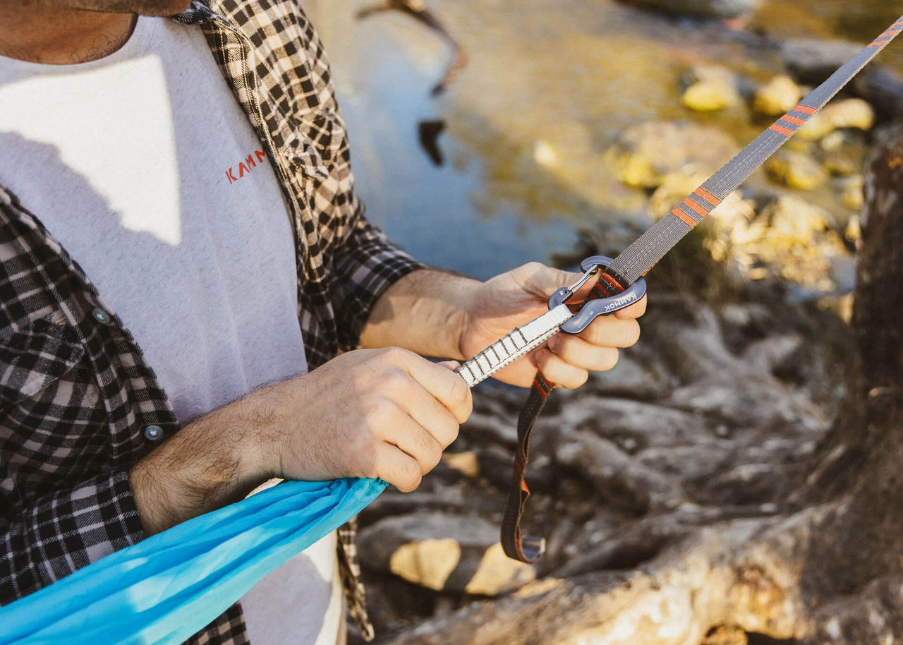 Close up of man attaching Python Straps to a Kammok Hammock Roo Double