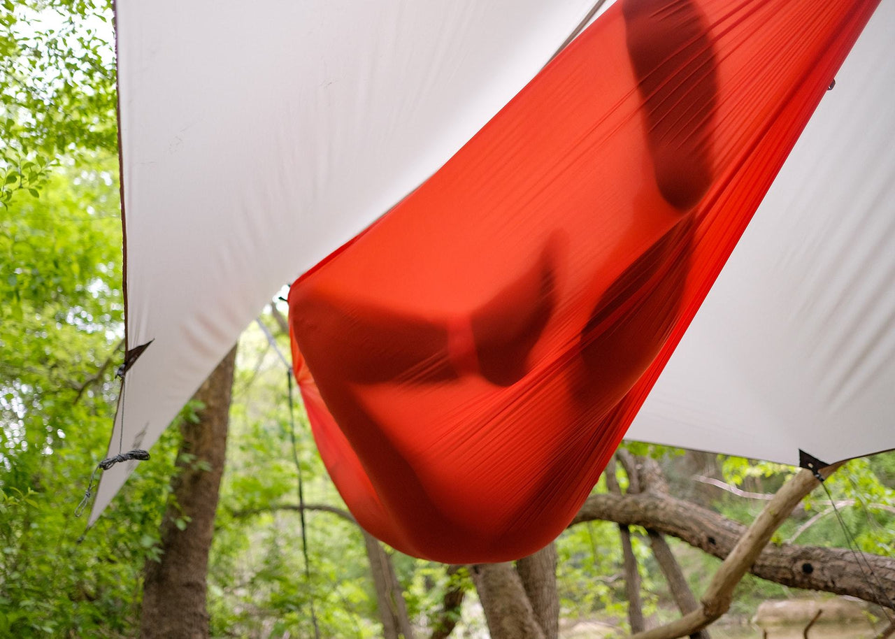 Underside of a Kammok Hammock Roo Single UL hanging between trees.