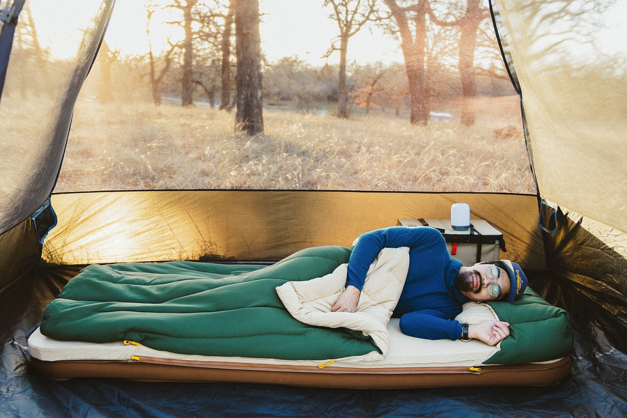 Man sleeping inside of a tent with the Kammok Ursa Sleep System.
