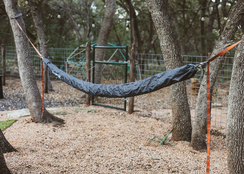 Kammok Wallaroo Hammock Sleeve in backyard over hammock hanging from Python Straps from tree.